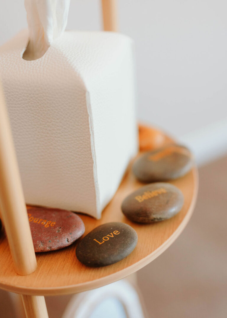 Smooth stones on a side table in a Hope and Wholeness therapy room