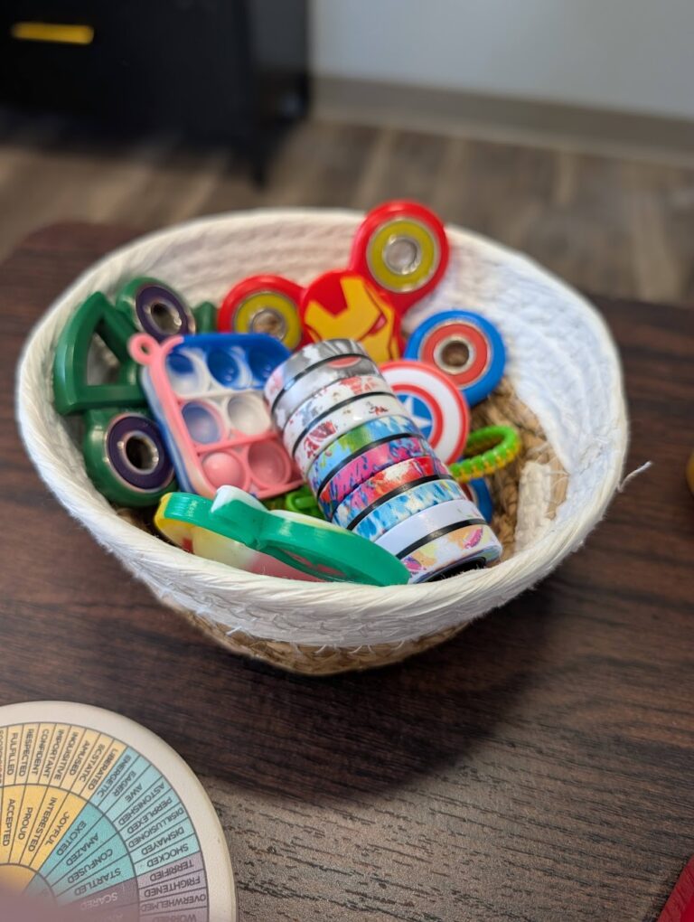 Bowl of fidget toys in a Hope and Wholeness therapy room
