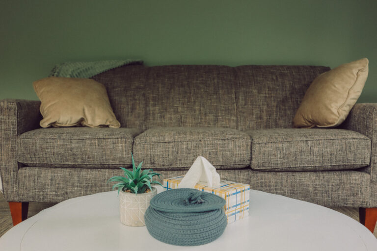 Couch and coffee table in a counseling room at the Hope and Wholeness Grand Rapids office